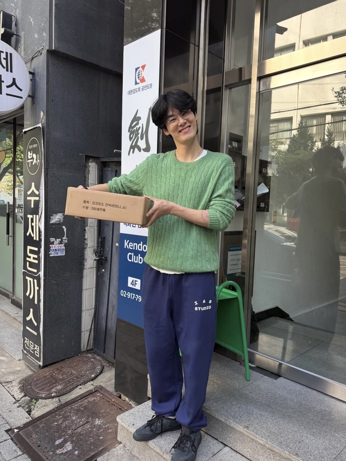 그린 니트에 파란색 스웨트팬츠를 더해 캐주얼하게 연출한 스타일링. / 이미지 출처: @keemwj