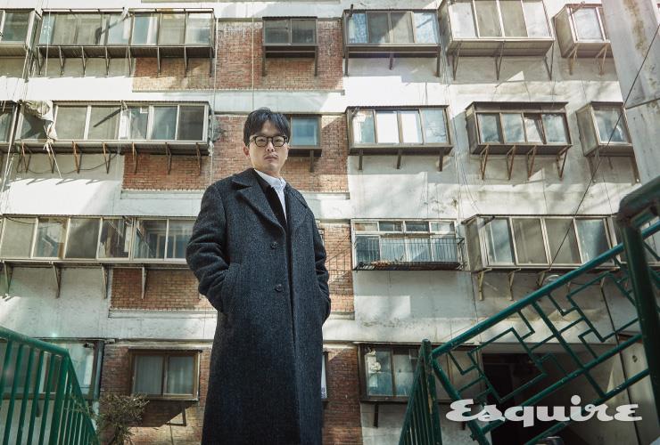 <스위트홈>에 등장하는 아파트의 외관은 회현 제2시민아파트에서 차용했다. 코트, 팬츠, 안경 모두 인터뷰이 소장품. BDU 재킷 22만9000원, 셔츠 9만9000원 모두 마티스 더 큐레이터.