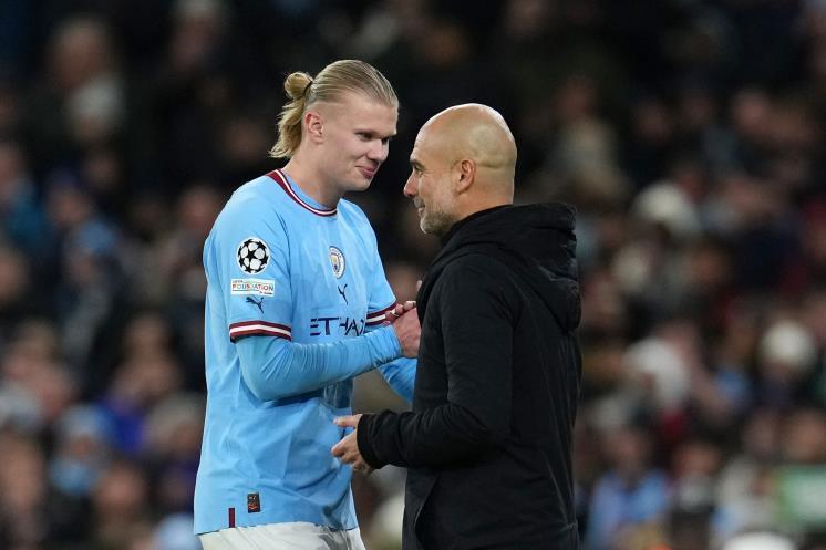 MANCHESTER, ENGLAND - MARCH 14: Pep Guardiola, Manager of Manchester City, embraces Erling Haaland of Manchester City after being substituted during the UEFA Champions League round of 16 leg two match between Manchester City and RB Leipzig at Etihad Stadium on March 14, 2023 in Manchester, England. (Photo by Lexy Ilsley - Manchester City/Manchester City FC via Getty Images)