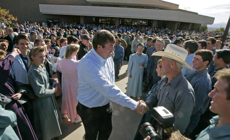ST. GEORGE, UT - NOVEMBER 14: Willie Jessop (C), spokesman for the FLDS Church, shakes the hands of polygamy supporters from Colorado City, Arizona gather at the Fourth District Courthouse, November 14, 2008 in St. George, Utah. Members of the polygamist sect in Colorado City gathered to protest the sale of anymore land from the FLDS Trust by the state of Utah. The hearing was postponed when representatives from the State of Utah and leaders from the polygamist sect agreed for the first time to negotiate the running of the trust and the sale of land. (Photo by George Frey/Getty Images)