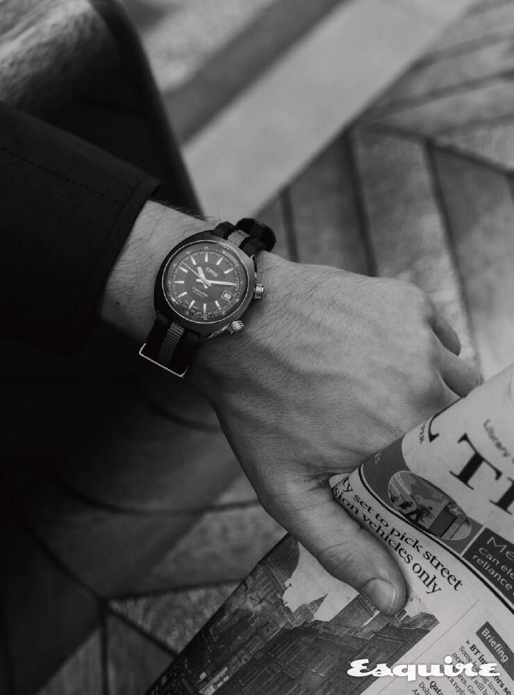 ORIS 크로노리스 데이트, 39mm 스테인리스스틸, 회색 나토 스트랩, 185만원. 남색 재킷 윌리엄 앤 선.
