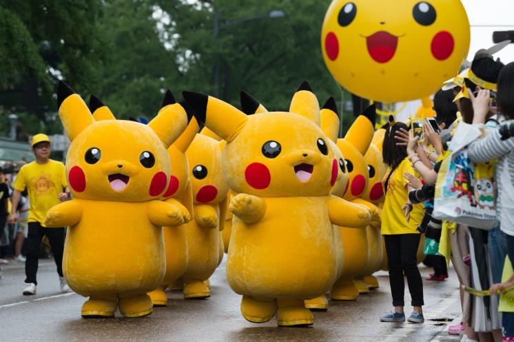 Performers dressed as the Pikachu character from Nintendo Co.'s Pokemon franchise march during the Pikachu Carnival Parade organised by Pokemon Co. in Yokohama, Japan, on Monday, Aug. 14, 2017. About 60 million people still play爐he Pokemon?o mobile game each month, according to data from mobile app research firm Apptopia, and?ne in five?f those players opens the game on a daily basis. Photographer: Akio Kon/Bloomberg via Getty Images